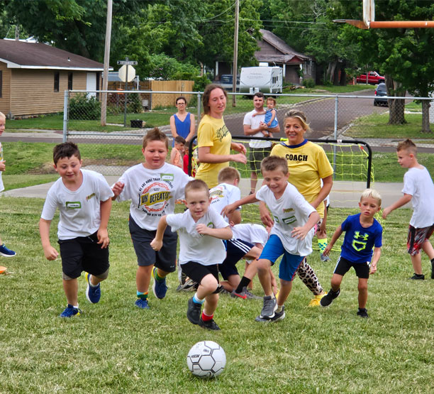 Children playing soccer in team camp